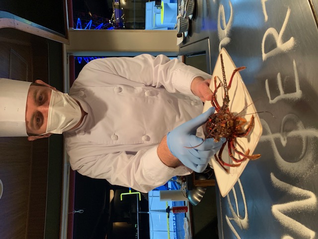 Chef preparing fresh lobster on board